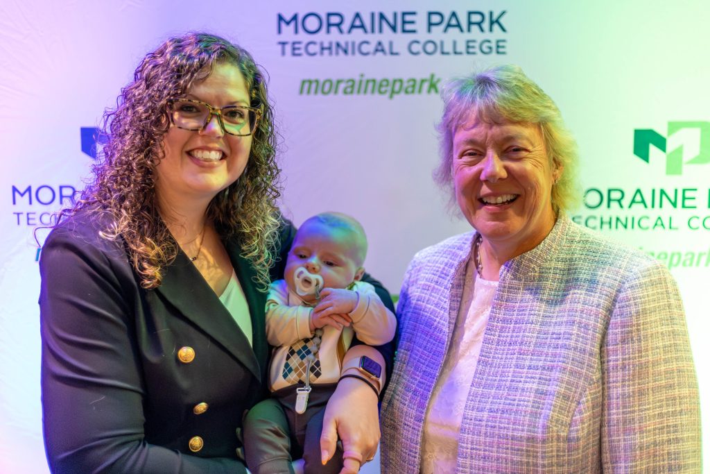 Abi Loehrke Halfmann posed with her baby and President Bonnie Baerwald.