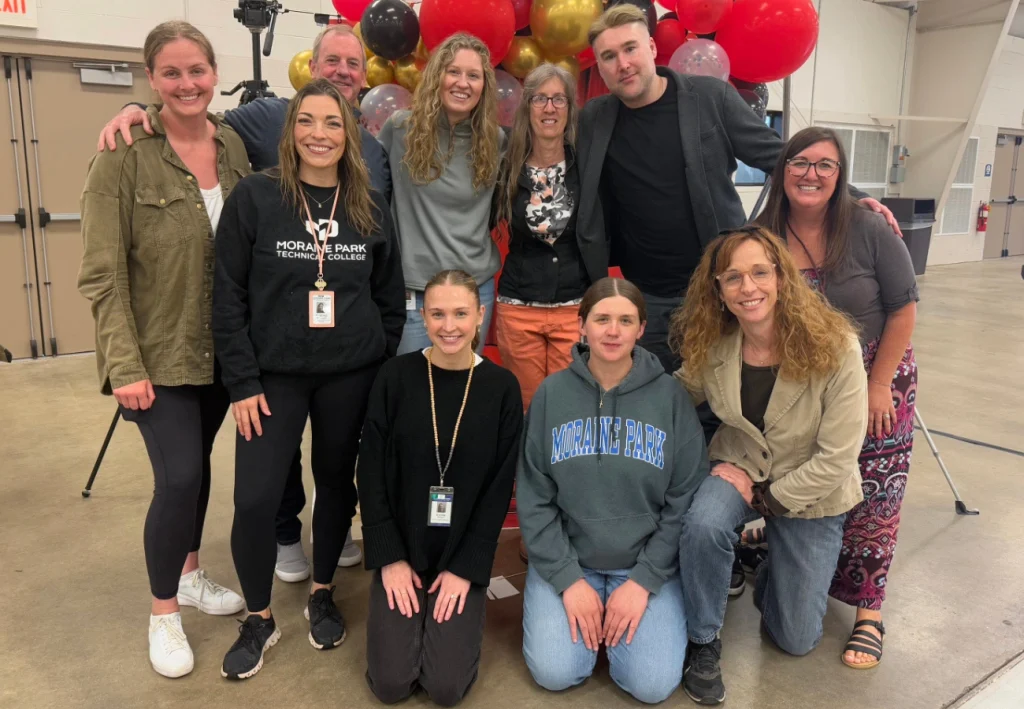 Marketing and Communications team doing a group photo at an event.
