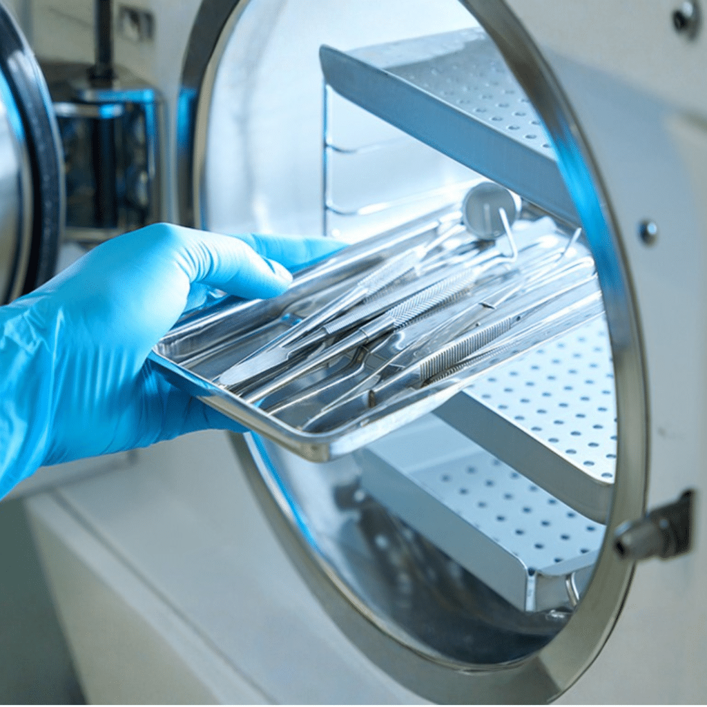 Sterile Processing Tech taking sterile instruments out of a sterilizing machine.