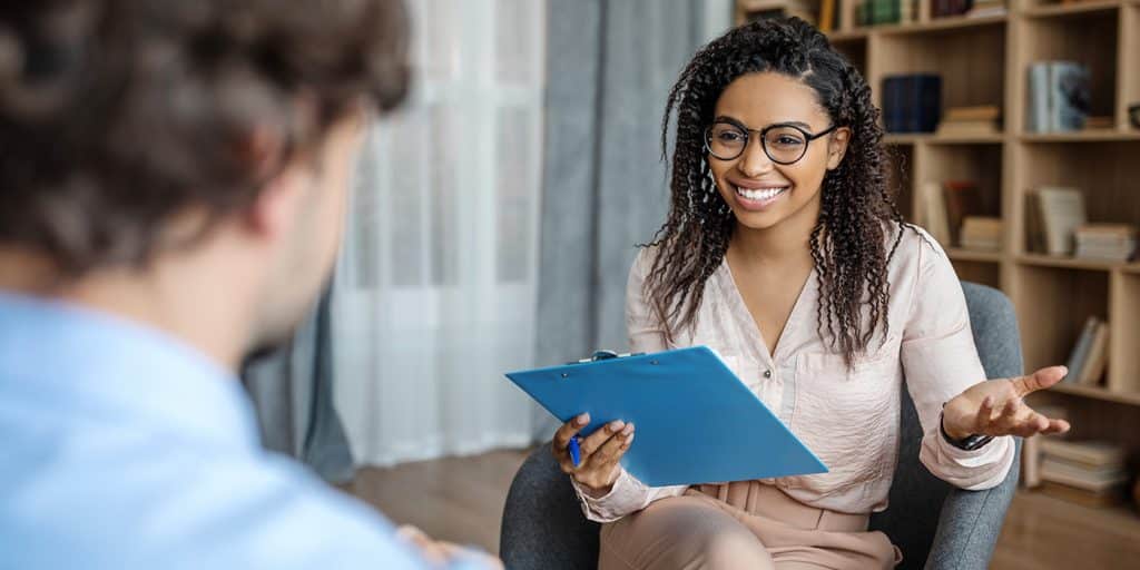 Smiling life coach talking to her client.